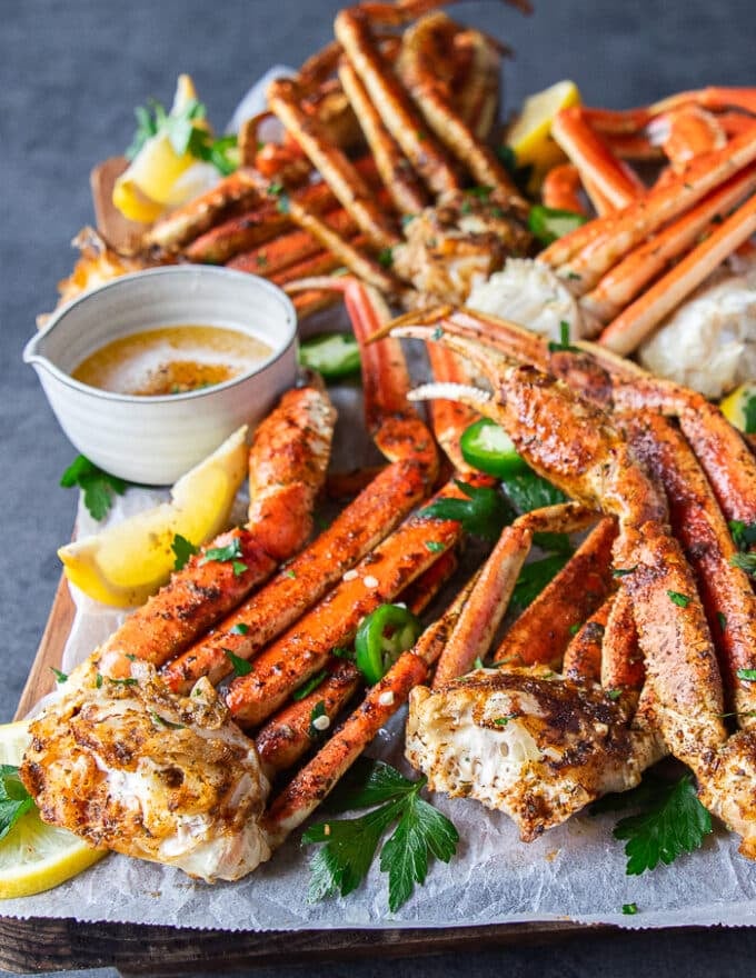 close up of a cooked crab leg showing the succulent meat inside and the dark orange shell