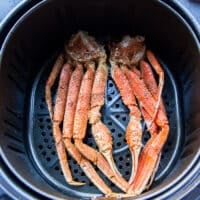 seasoned crab legs in a large air fryer basket