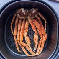 Air fried crab legs ready to eat in an air fryer basket