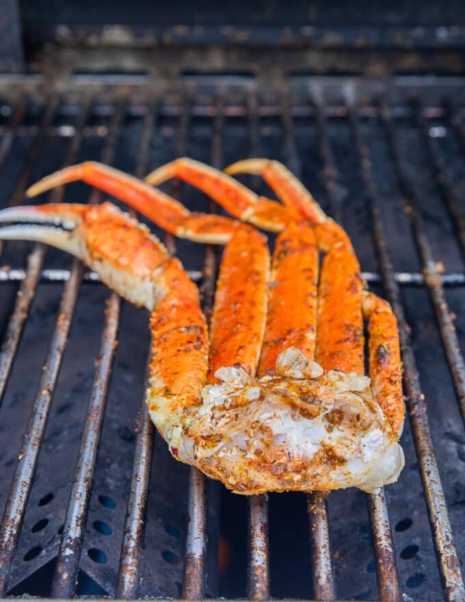 Crab legs grilled and charred on a grill, ready to enjoy