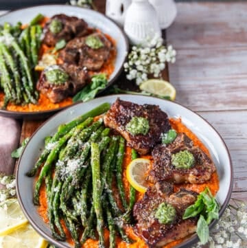 side view of a plated lamb chops dinner showing the thickness of the cooked lamb chops