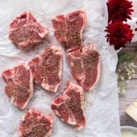 lamb chops on a paper seasoned liberally with coarse salt and pepper on both sides