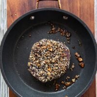 The ahi tuna seared on high heat in a skillet