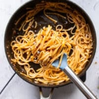 Pasta tossed in lots of chili oil until it has a deep red color, and some cream on the side to make creamy chili crab pasta