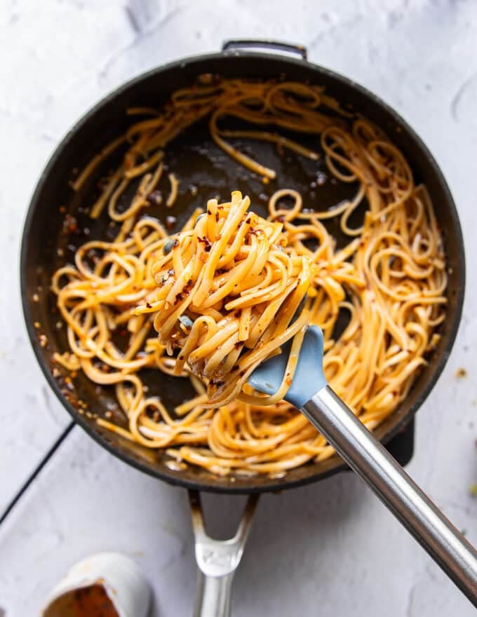 Pasta tossed in lots of chili oil until it has a deep red color, and some cream on the side to make creamy chili crab pasta 