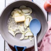 Onion and butter sautéing in the pan to cook the rice