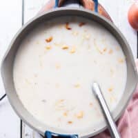 The coconut milk is added to the pot of rice