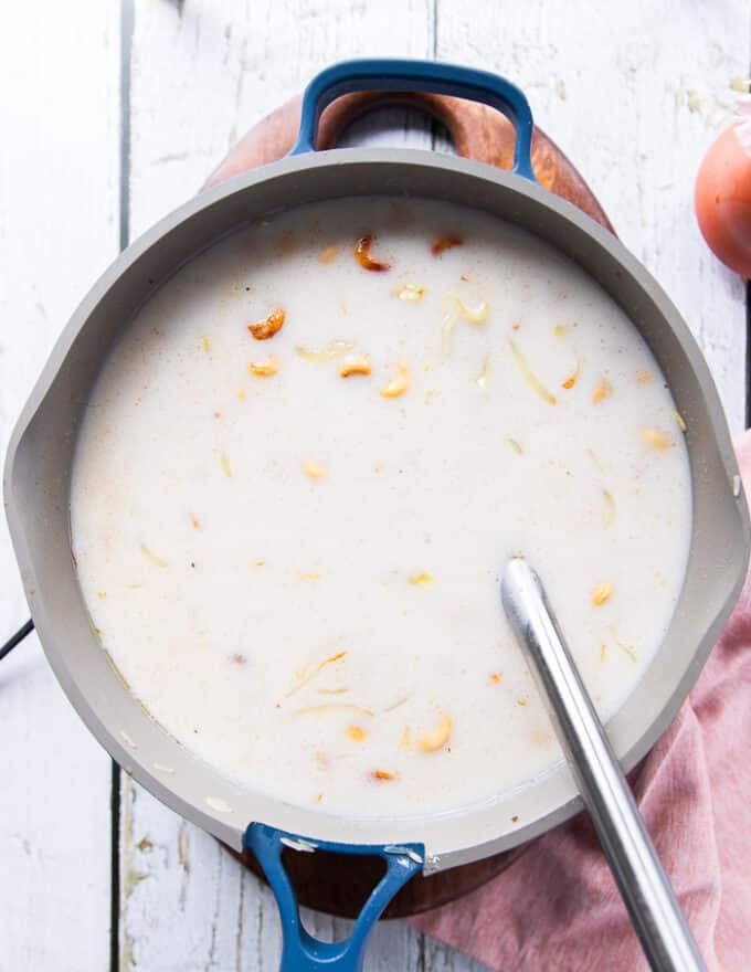 The coconut milk is added to the pot of rice 