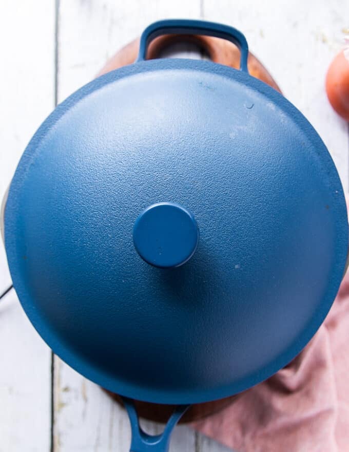 The rice pot is fully covered and the coconut rice cooks over low heat