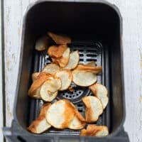 golden air fried potatoes in a basket of the air fryer