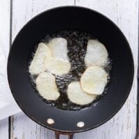 a few potato slices frying in very hot oil
