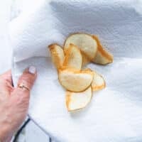 The potato chips removed from the oil and placed on paper towels to drain