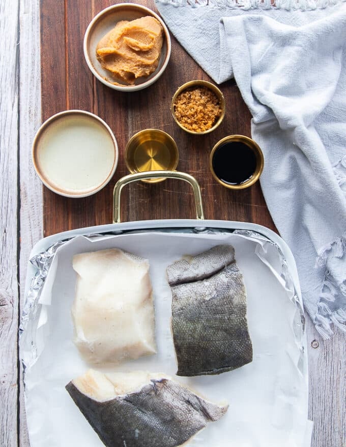 ingredients to make miso cod recipe including black cod, miso paste, mirin, sake, brown sugar and soy sauce 