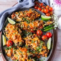 The stuffed poblanos with the melted cheese on top out of the oven and on to a serving plate with fresh cilantro garnish
