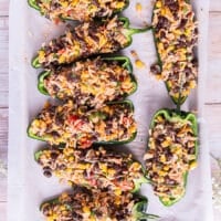 The poblano pepper halves on the baking sheet filled with the stuffing