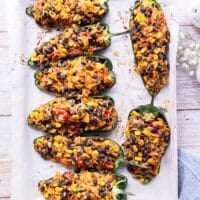 Stuffed Poblano peppers on a baking sheet out of the oven ready for the cheese.