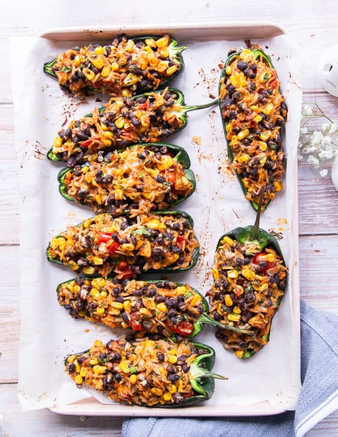 Stuffed Poblano peppers on a baking sheet out of the oven ready for the cheese.