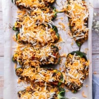 Cheese is sprinkled over the stuffed poblanos as a final step before baking for another 5 minutes to melt the cheese