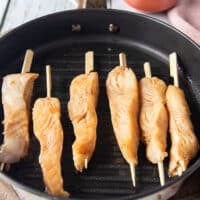 Halibut skewers on a hot indoor grill, all in one layer