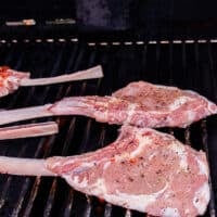 the veal chops placed on a grill