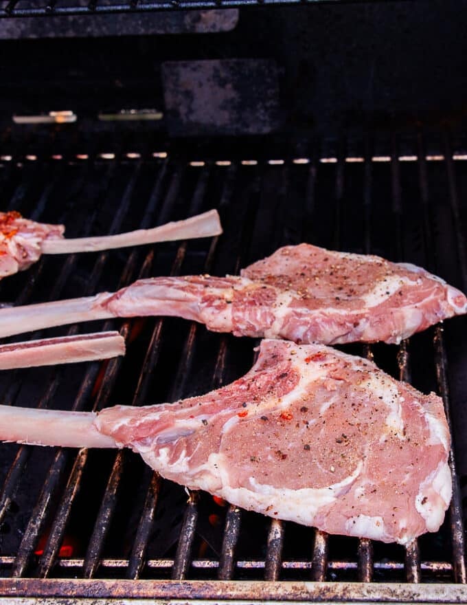 the veal chops placed on a grill