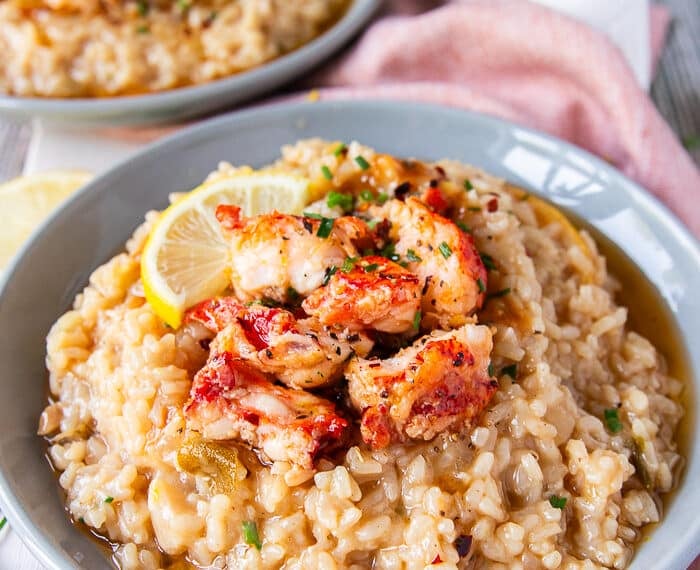 side view of a plate of lobster risotto fully plated and garnished