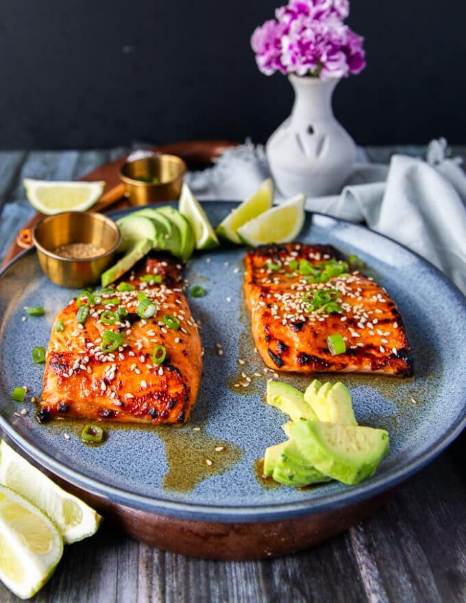 side view of two miso salmon fillets cooked and served on a plate