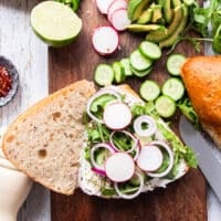 Some toppings starting to pile at the smoked salmon sandwich like arugula, onions, radishes