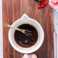 A bowl with soy sauce, sesame oil, rice vinegar, sugar, seasoning mixed together to make the sauce for soba noodles recipe