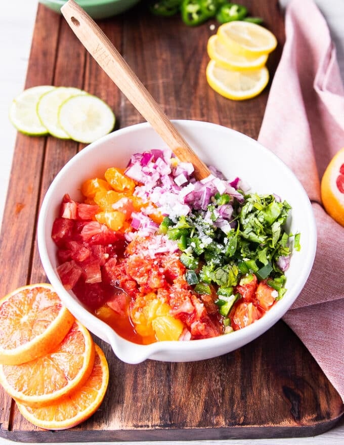 All the citrus salsa ingredients added to one bowl at the same time 