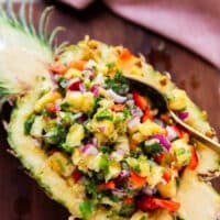 close up of a half pineapple stuffed with the pineapple salsa for a beautiful presentation