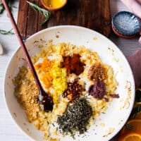 After the onions have cooked, the remaining ingredients are added including garlic, mustard, tapenade, citrus zests and spices