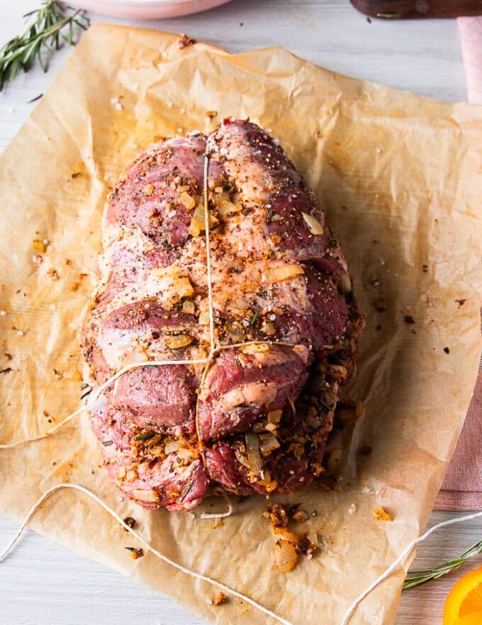 The kitchen twine is then used to tie the first knot around the circumference of the boneless leg of lamb and within every round, a knot os formed 