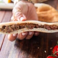 the meat mixture is pressed firmly into the pita bread