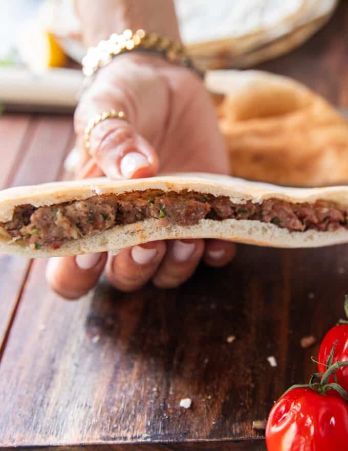the meat mixture is pressed firmly into the pita bread 