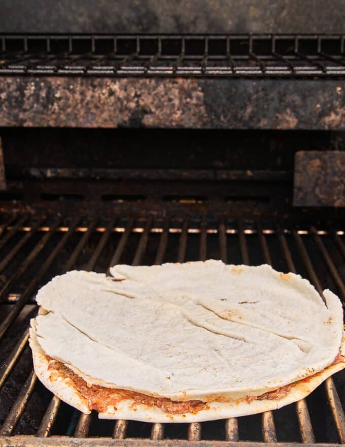 The thin pita on the grill cooking 