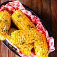 corn on the cob cooked and boiled, slathered in butter and placed in a plate to serve