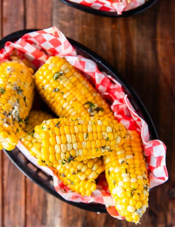 corn on the cob cooked and boiled, slathered in butter and placed in a plate to serve