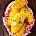 Close up of boiled corn. on the cob slathered with butter