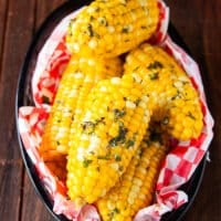 Close up of boiled corn. on the cob slathered with butter