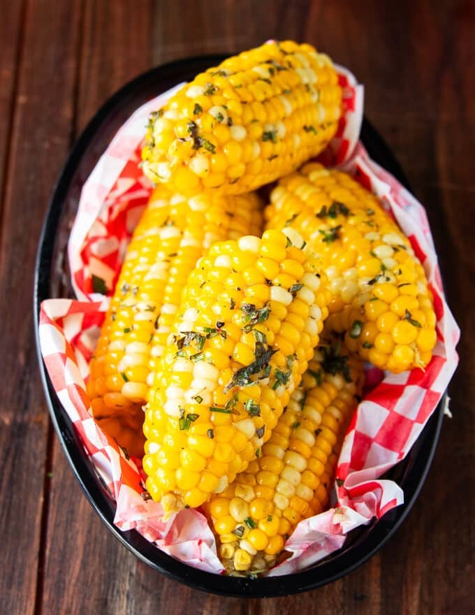 Close up of boiled corn. on the cob slathered with butter