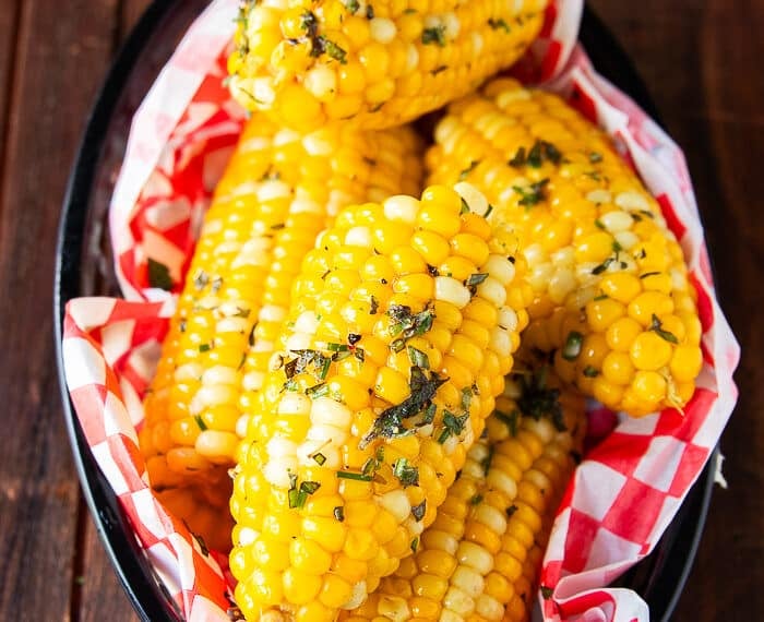 Close up of boiled corn. on the cob slathered with butter