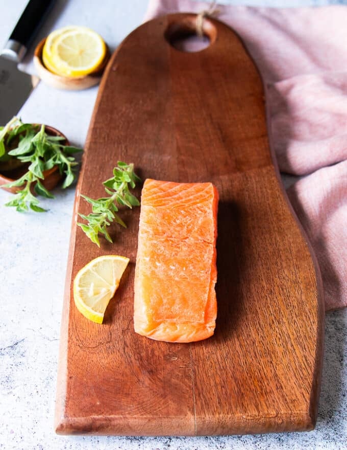 A whole salmon fresh sushi grade, partially frozen and ready to slice for salmon carpaccio 