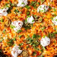 close up of a small piece of the taco spaghetti skillet showing the texture of the melted cheese, and toppings