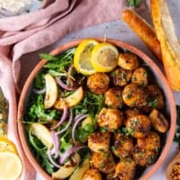 finished plate of broiled scallops with a side of salad