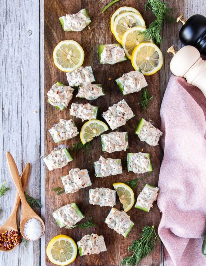 a full plate of ready to serve tuna cucumber salad surround by a tea towel and some lemon slices