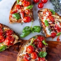 Each toast is cut into two smaller toasts with the juicy tomatoes, cheese and basil on top