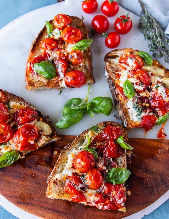 Each toast is cut into two smaller toasts with the juicy tomatoes, cheese and basil on top