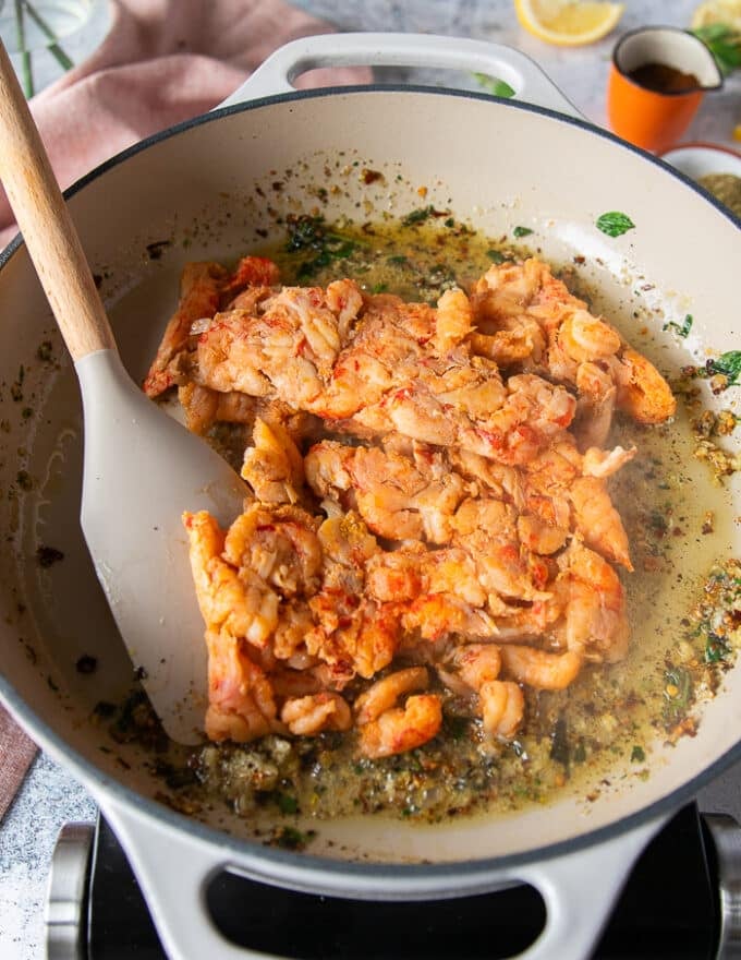 the crawfish tail meat is added to the skillet 