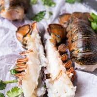 A lobster tail split in half with the meat inside ready to season